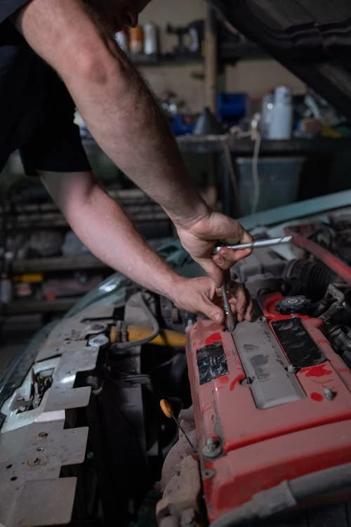 Car Mechanic Fixing the Engine of Car