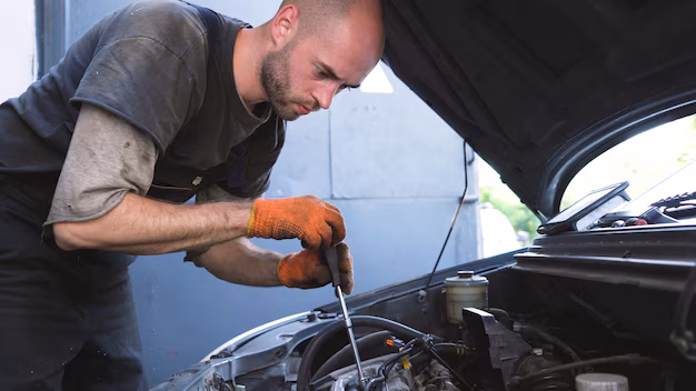 auto-mechanic-changing-air-filter-car